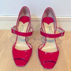 Jimmy Choo neon pink patent peep toe heels.